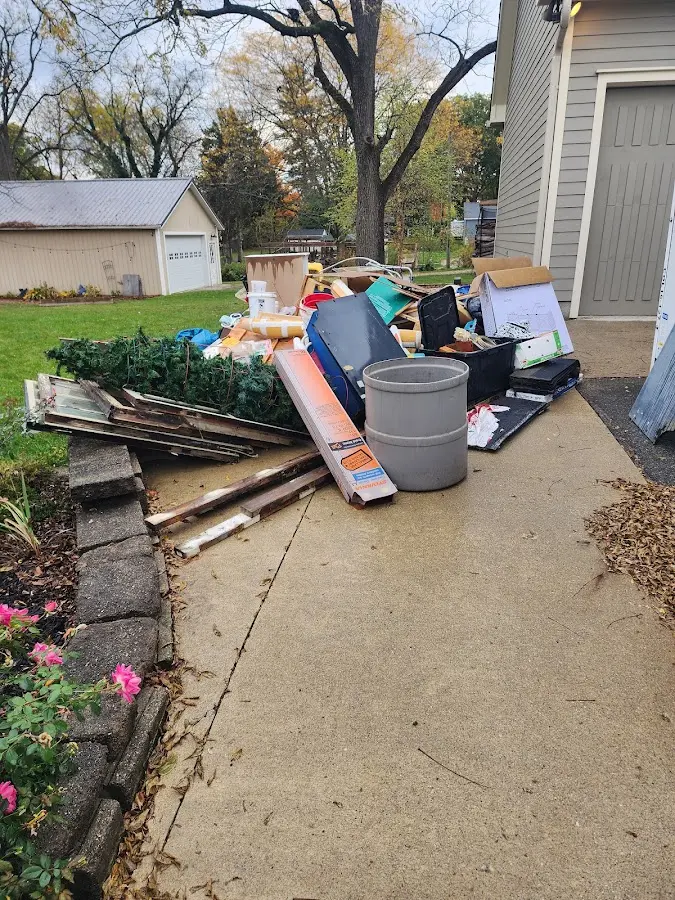 Dumpster being loaded with debris for 12 Yard Dumpster Rental in West Samoset